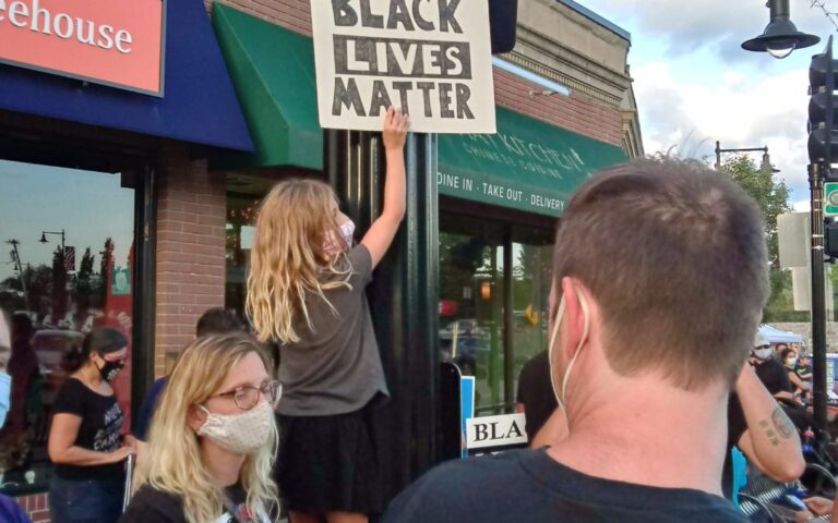 Girl holding Black Lives Matter sign in Dedham Square